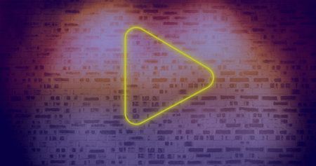 Image of neon play symbol over brick wall. Social media, communication, advertisement and neon...