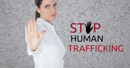 Composite of caucasian businesswoman showing stop sign and stop human trafficking text. Copy space, gesture, crime, freedom, awareness and prevention concept.の写真素材