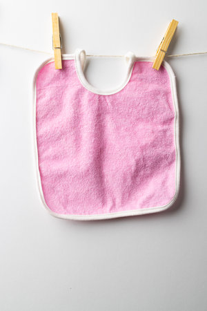 Close up of baby bib on white background. Clothing and accessories, newborn and infant childcare concept.の写真素材