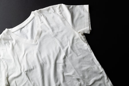 Close up of white tshirt and copy space on black background. Clothing, fashion and retail concept.の写真素材