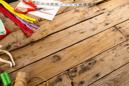 Composition of sewing equipment on wooden background with copy space. National craft month, sewing,...