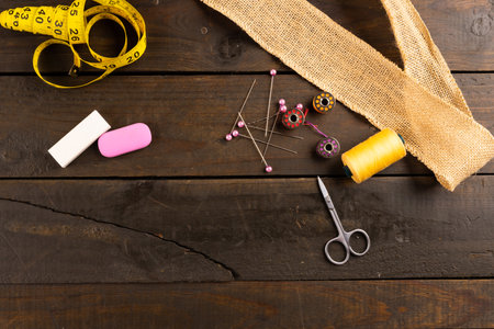 Composition of sewing equipment on wooden background with copy space. National craft month, sewing,...