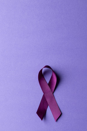 Vertical composition of purple add or adhd awareness ribbon on purple background, with copy space....
