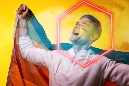 Male caucasian player with german flag screaming over illuminated hexagon against yellow background....