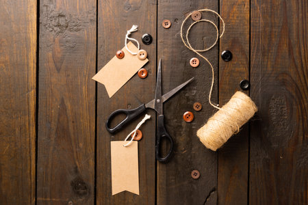 Composition of sewing equipment on wooden background. National craft month, sewing, clothes and copy space.の写真素材