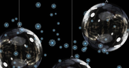 Snow falling over baubles on black background. christmas, tradition and celebration concept digitally generated image.の写真素材