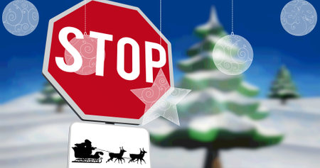 Image of baubles over stop sign with santa claus in sleigh with reindeer in winter scenery....
