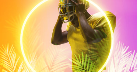 Composite of american football player removing helmet by illuminated circle and plants, copy space....