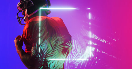 Side view of american football player in red uniform and helmet by illuminated square and plants. Copy space, composite, sport, competition, illustration, glowing, nature, shape and abstract concept.の写真素材