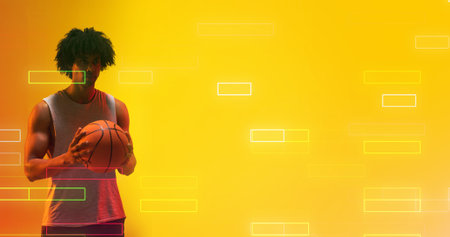 Composite of biracial male player holding basketball by illuminated rectangles on yellow background....