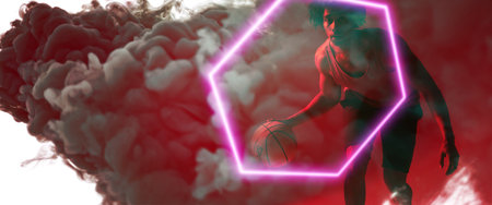 Composite of biracial basketball player playing with ball by hexagon over smoky background. Copy...