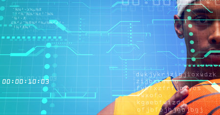 Close-up of biracial basketball player holding ball over grid pattern with computer language. Copy...