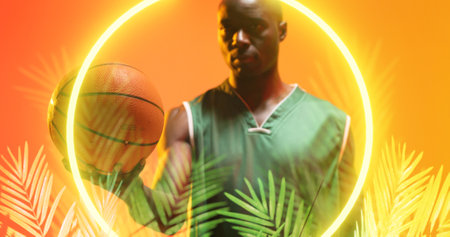 Portrait of african american player holding basketball by circle and plants on yellow background....