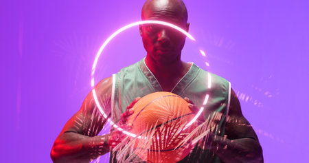 Portrait of bald african american basketball player holding ball by glowing circle and plants. Copy space, purple, composite, sport, competition, illustration, illuminated, nature, shape, abstract.の写真素材