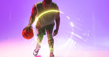 African american basketball player dribbling ball by glowing circle and plants on purple background. Composite, copy space, sport, competition, illustration, illuminated, nature, shape and abstract.の写真素材