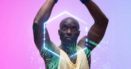 Bald african american basketball player with arms raised by illuminated hexagon and plants. Composite, copy space, sport, competition, illustration, glowing, nature, shape and abstract concept.の写真素材