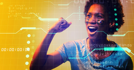 Biracial soccer player with brazilian flag's face paint screaming on computer language and grid. Composite, sport, competition, match, coding, achievement, yellow, shape and abstract concept,の写真素材