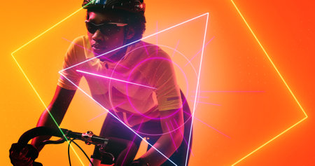 Biracial female cyclist wearing glasses and helmet riding bike over illuminated geometric shapes. Yellow, copy space, composite, sport, cycling, racing, competition, shape and abstract conceptの写真素材