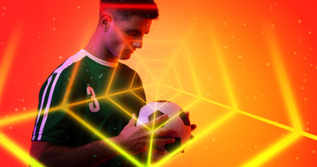 Digital composite of young caucasian player holding soccer ball seen through with neon spider web. Computer graphic, soccer, copy space, sport, design, athlete, competitive sport.の写真素材