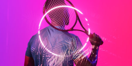 Illuminated plants and circle over rear view of african american male tennis player holding racket. Copy space, composite, sport, competition, shape, nature playing, match and abstract.の写真素材