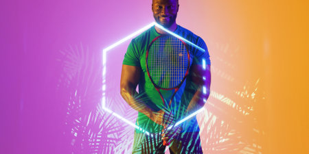 Illuminated plants and hexagon over smiling african american male player holding tennis racket. Copy...
