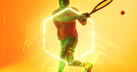 African american player playing tennis with racket and ball by illuminated hexagon and plants. Copy space, composite, sport, competition, shape, nature, playing, match and abstract concept.の写真素材