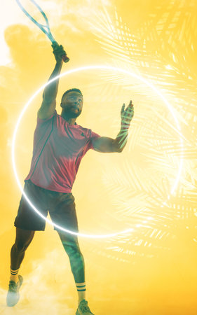 African american male tennis player hitting ball with racket by illuminated circle and plants. Copy space, composite, sport, competition, playing, match, nature, shape and abstract concept.の写真素材