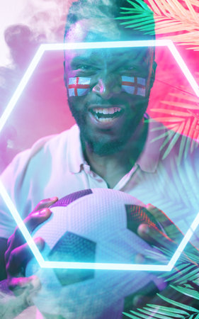 African american man with england flag&#39;s face paint holding ball over illuminated plants and hexagon. Copy space, composite, soccer, patriotism, sport, competition, nature and abstract concept.の写真素材
