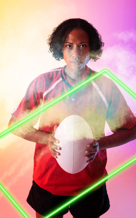 Composite of biracial female rugby player holding ball and standing over illuminated rectangle. Copy...