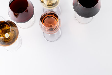 Glasses with red, rose and white wine on white background, with copy space. Wine week, drink and celebration concept.の写真素材