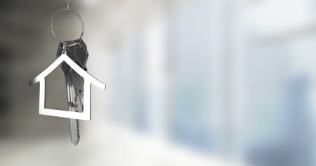 Image of keys with house keychain over blurred background. Moving house and digital interface...
