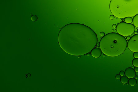 Macro close up of water bubbles with copy space on green background. Macro, colour, water, shape and pattern concept.の写真素材