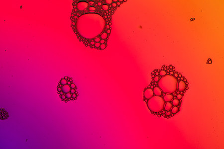 Macro close up of water bubbles with copy space over purple and orange background. Macro, colour,...