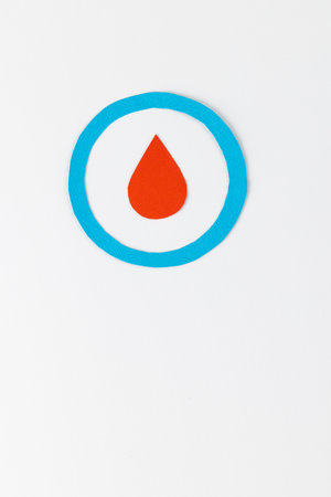 Blood drop in blue ring on white background with copy space. Blood sugar, diabetes and health awareness.の写真素材
