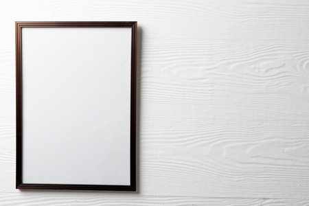 Black empty frame with copy space on white wall. Mock up frame template, interior design and decoration.の写真素材