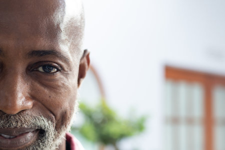 Portrait of happy african american male doctor smiling at doctor&#39;s office, copy space. Hospital, medicine and healthcare.の写真素材