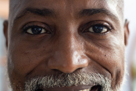 Portrait of happy african american male doctor looking at camera and smiling at doctor's office....