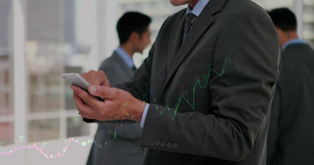 Composition of financial data processing over caucasian businessman using smartphone. Global...