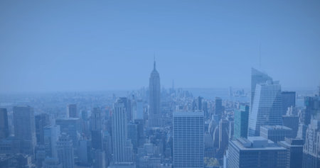 Image of modern cityscape over blue background. Global business and digital interface concept digitally generated image.の写真素材