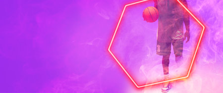 Low section of african american basketball player with ball walking by hexagon on purple background. Copy space, composite, illuminated, sport, competition, illustration, shape and smoke concept.の写真素材