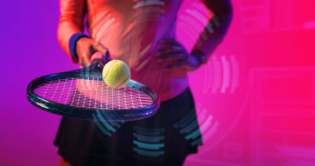 Midsection of biracial female tennis player practicing with racket and ball over circular pattern....