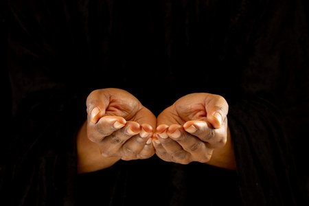 Image of close up of hands of african american woman praying. Easter, religion, tradition and celebration concept.の写真素材