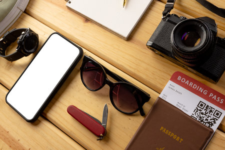 Travel equipment and smartphone with copy space on screen on wooden background. Travel and vacation.の写真素材
