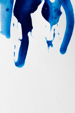 Close up of blue paint shapes on white background with copy space. Abstract background, pattern and colour.の写真素材