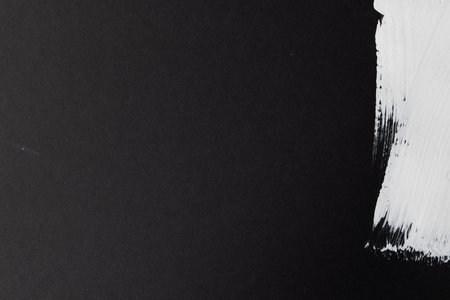 Close up of white paint stripe on black background with copy space. Abstract background, pattern and colour.の写真素材