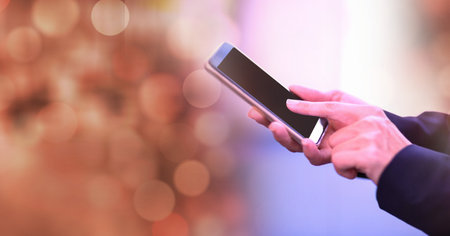 Composition of light circles over caucasian businesswoman using smartphone. global communication and...