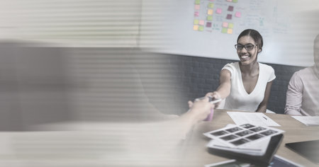 Composition of two happy diverse businesspeople shaking hands with motion blur. global business,...