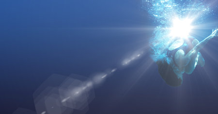 Composition of female swimmer turning under water with copy space and glowing light. sport, fitness and active lifestyle concept digitally generated image.の写真素材