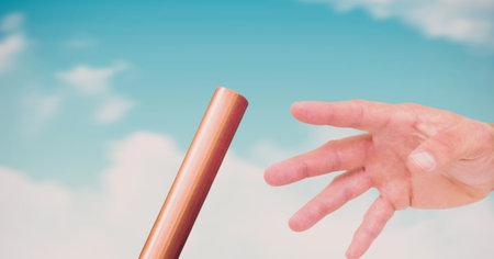 Composition of midsection of caucasian athlete passing orange relay baton. sports and competition concept digitally generated image.の写真素材