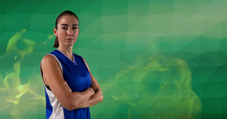 Composition of female basketball player standing with arms crossed, over smoke on green background. sport and competition concept digitally generated image.の写真素材